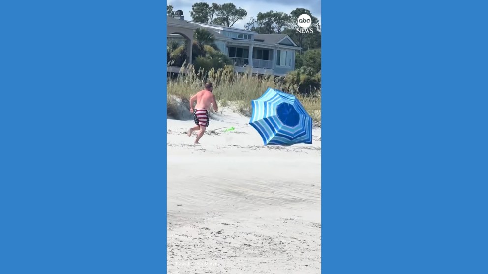 Video Man in patriotic bathing suit chases runaway beach umbrella | FROUSA Media Video Man in patriotic bathing suit chases runaway beach umbrella | FROUSA Media