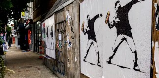 The man who threw a sandwich at a federal agent says it was a protest. Prosecutors say it’s a crime