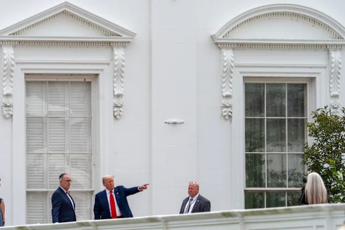Trump takes an unexpected walk on the White House roof to survey new projects