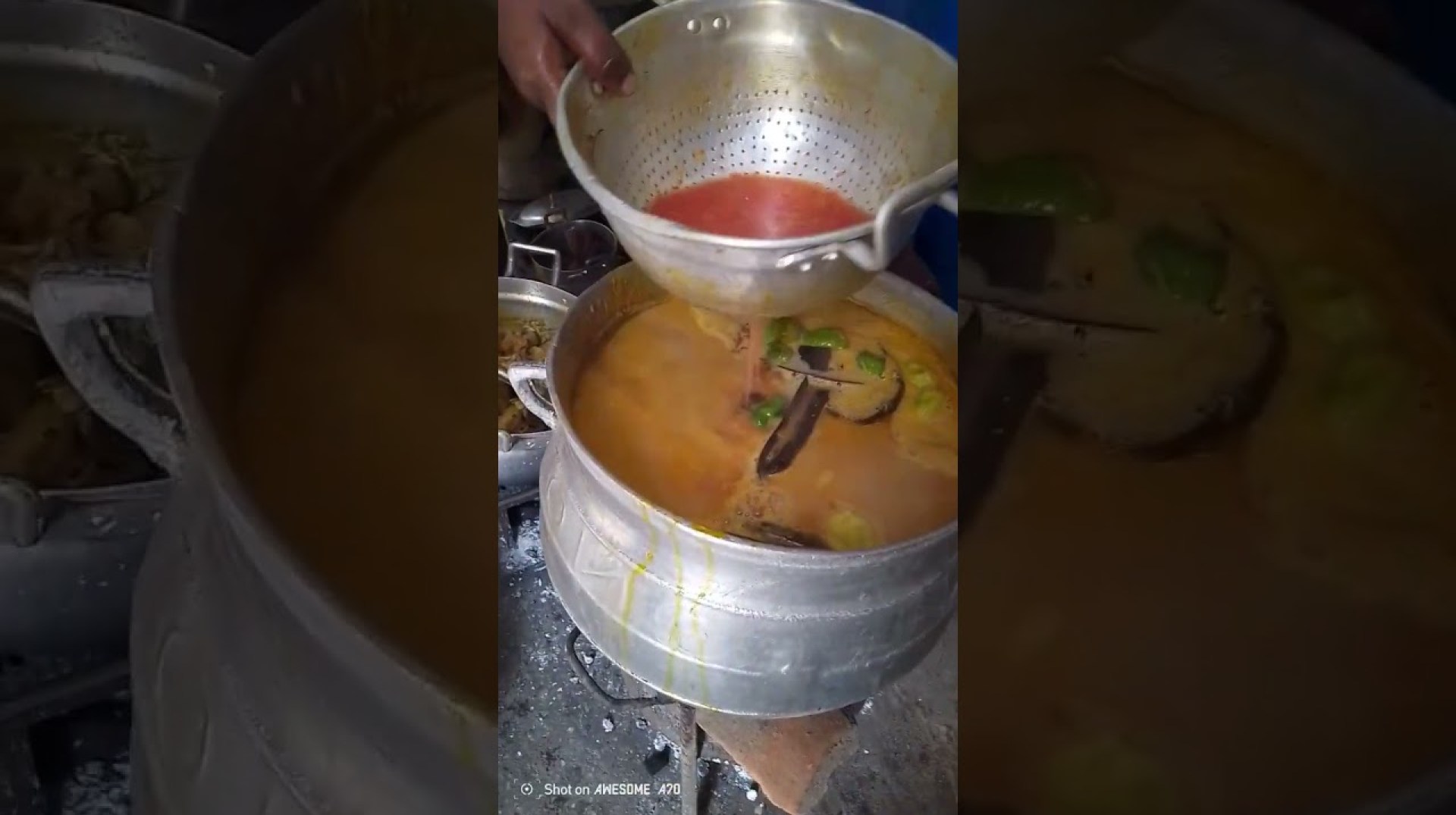Sieving grinded tomatoes for African food village recipes Sieving grinded tomatoes for African food village recipes