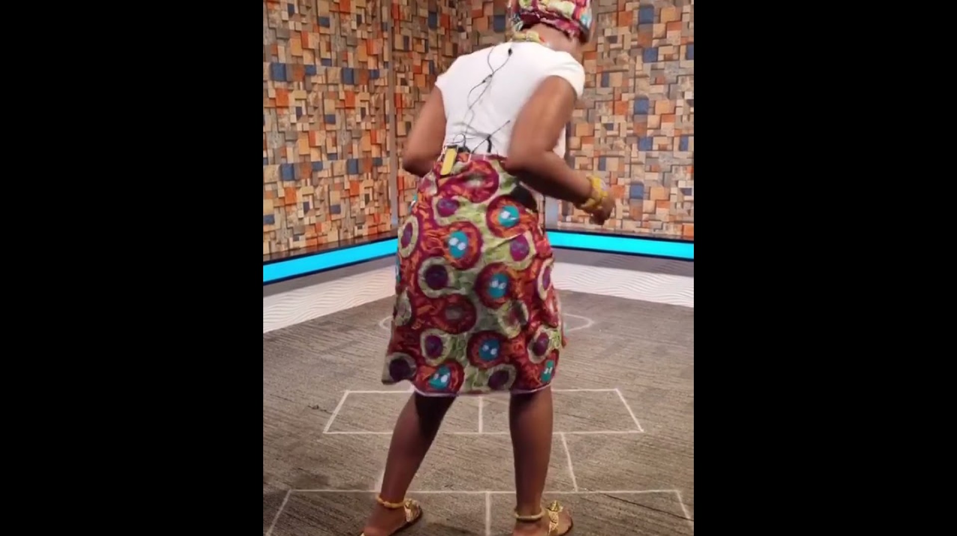 Berla Mundi plays a traditional game wearing a cultural attire Berla Mundi plays a traditional game wearing a cultural attire
