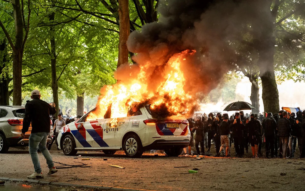 Rioters assault police in anti-migrant protests in The Hague Rioters assault police in anti-migrant protests in The Hague