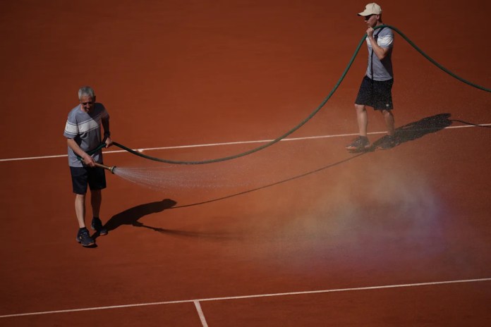 French Open groundskeepers drench the clay courts with water and salt during heat wave French Open groundskeepers drench the clay courts with water and salt during heat wave