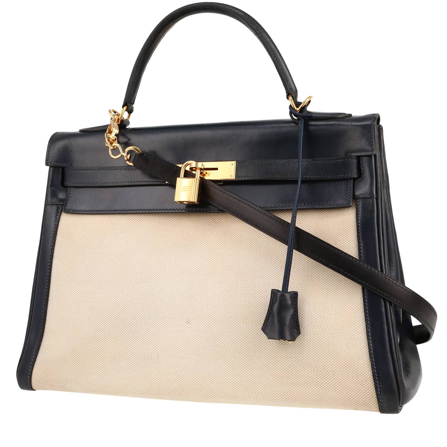 Sac Hermès Kelly 32 cm en toile beige et cuir Box bleu-marine avec quincaillerie dorée, bandoulière amovible – vue face
