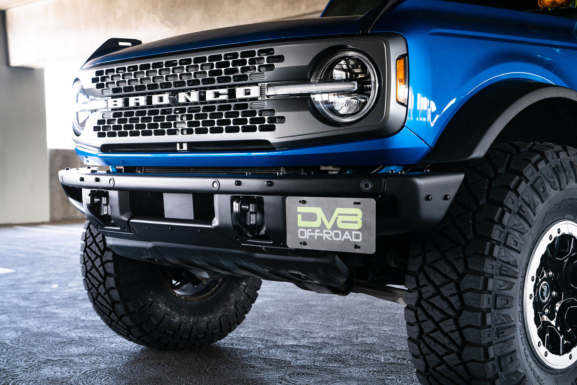 DV8 Offroad Front license plate relocation bracket places plate to the side of the bumper. LPBR-02