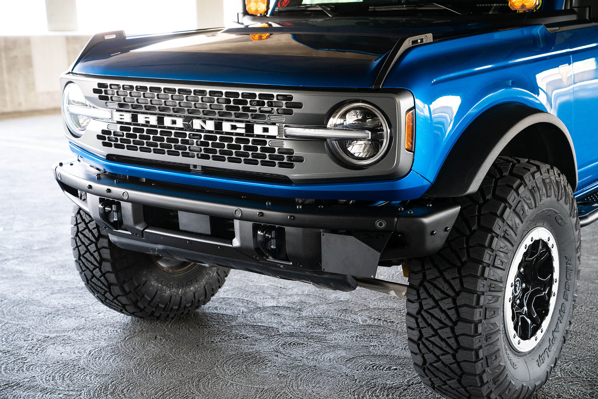 DV8 Offroad Front license plate relocation bracket places plate to the side of the bumper. LPBR-02