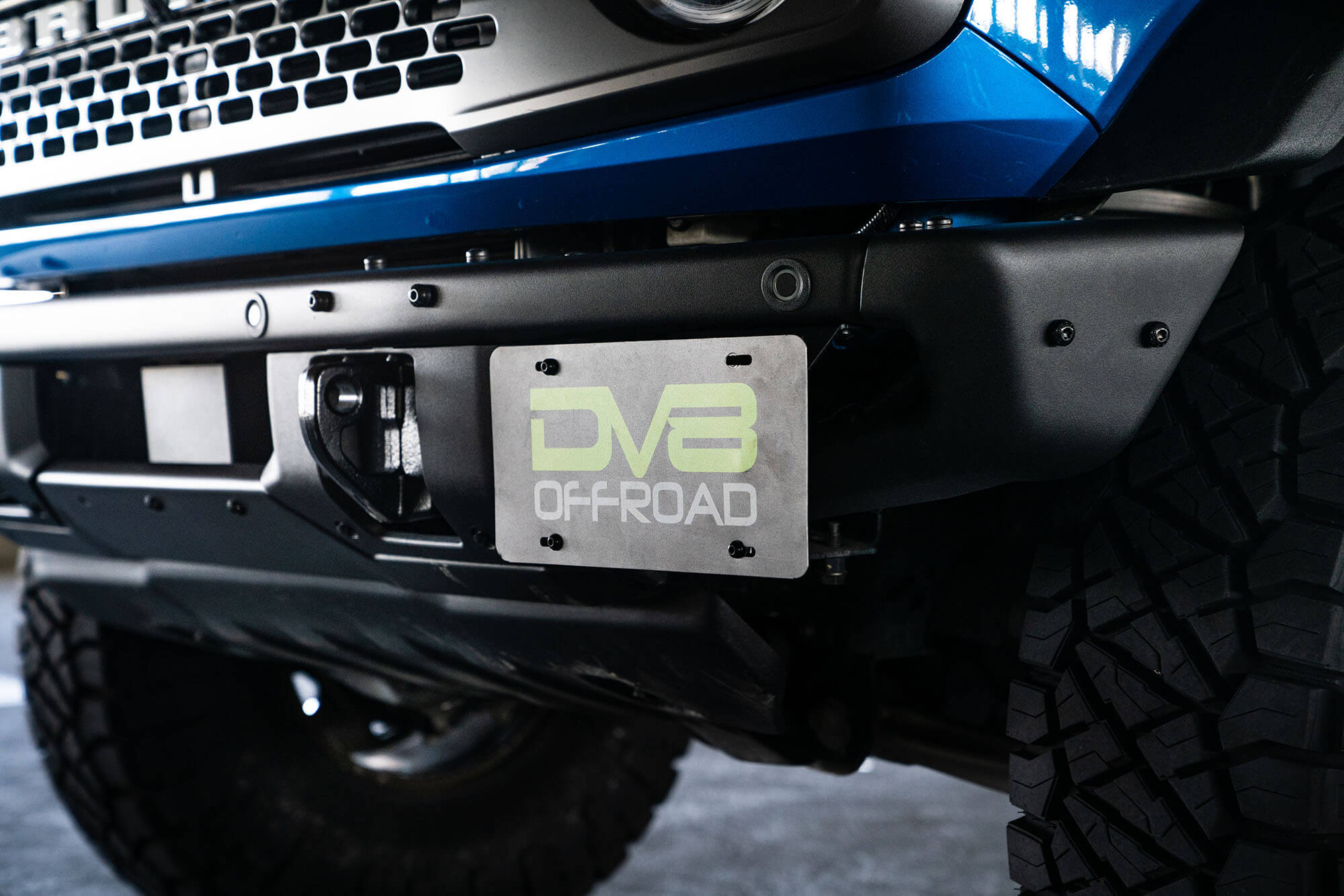 DV8 Offroad Front license plate relocation bracket places plate to the side of the bumper. LPBR-02