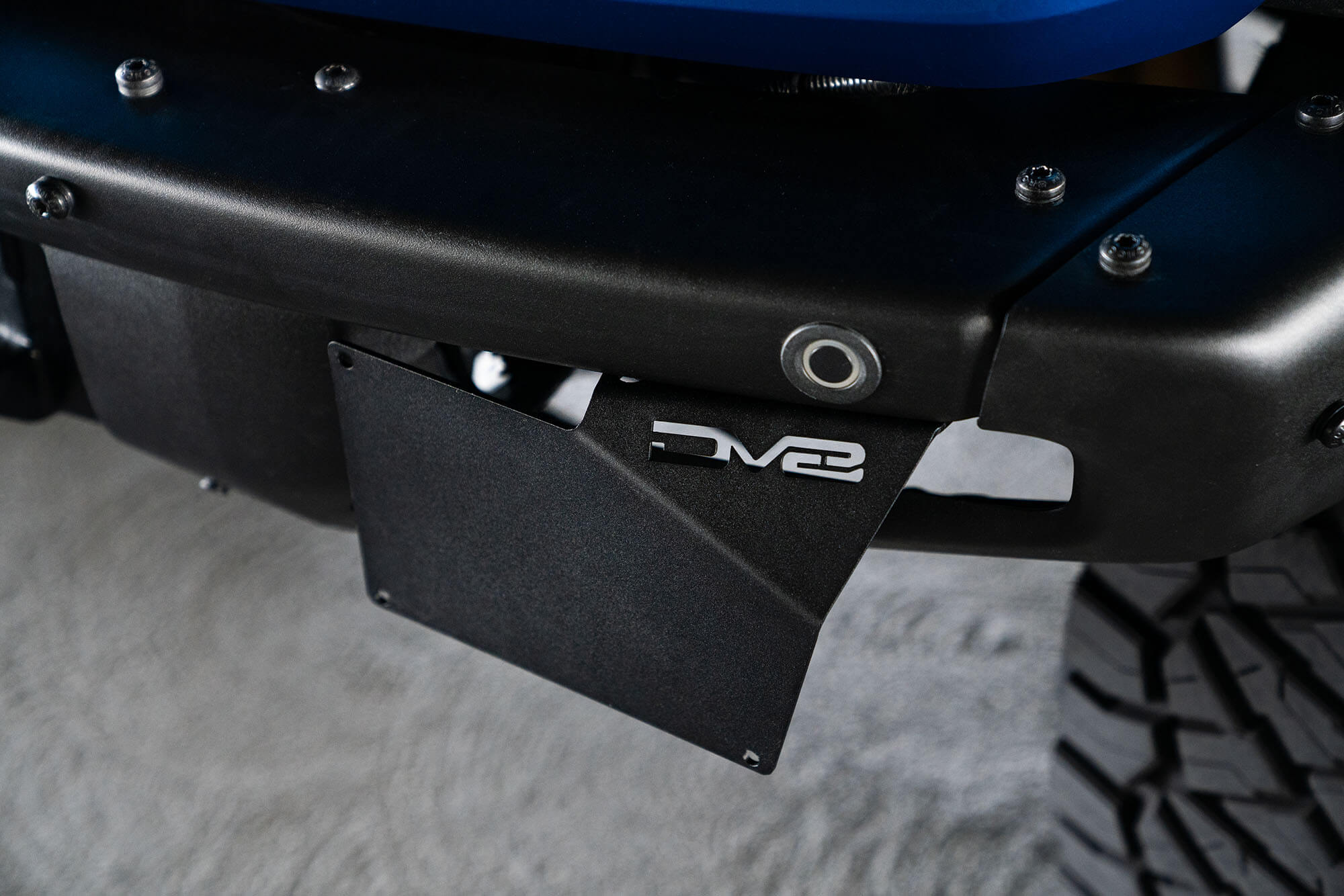 DV8 Offroad Front license plate relocation bracket places plate to the side of the bumper. LPBR-02