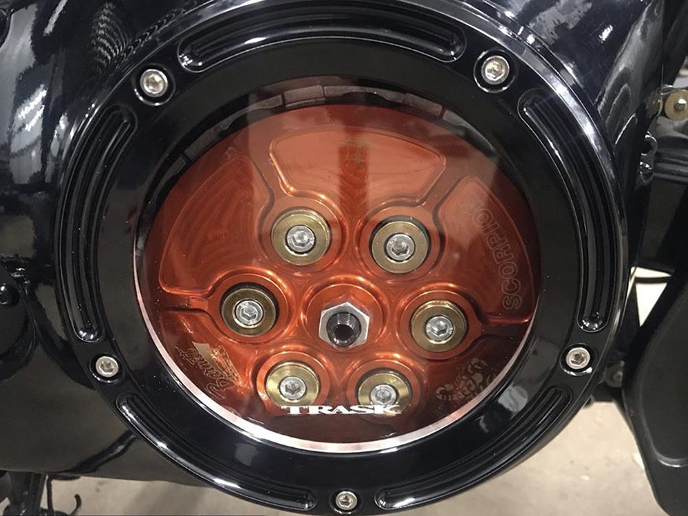 Trask Performance Assault Clear Derby Cover – Gloss Black. Fits Softail 1999-2018, Dyna 1999-2017 & Touring 1999-2015.