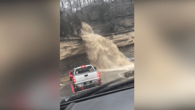 Raging Indiana waterfall pours floodwater onto cars below Raging Indiana waterfall pours floodwater onto cars below