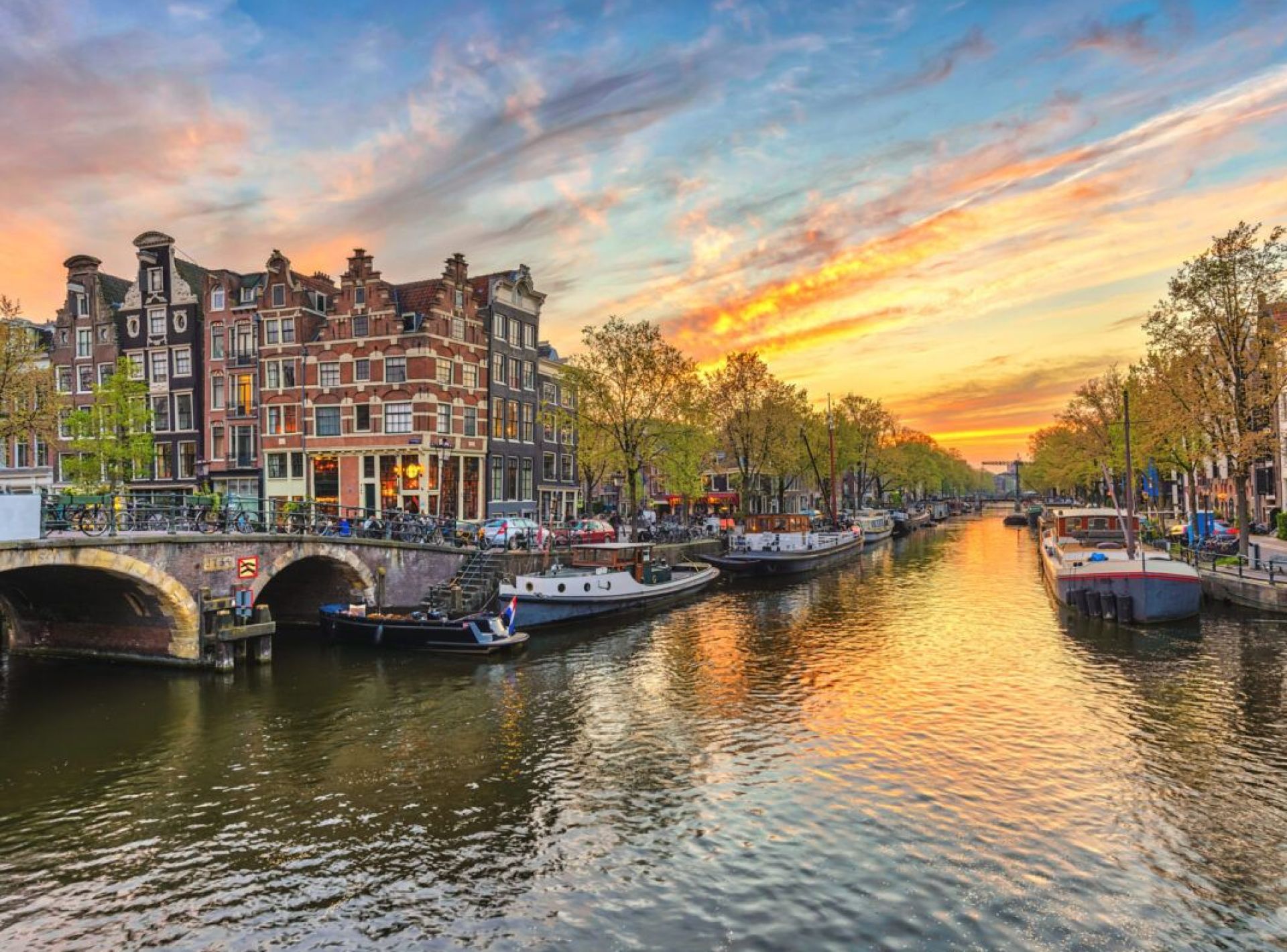 Scenic view of the Netherlands featuring traditional windmills, green fields, and a serene sky. Scenic view of the Netherlands featuring traditional windmills, green fields, and a serene sky.
