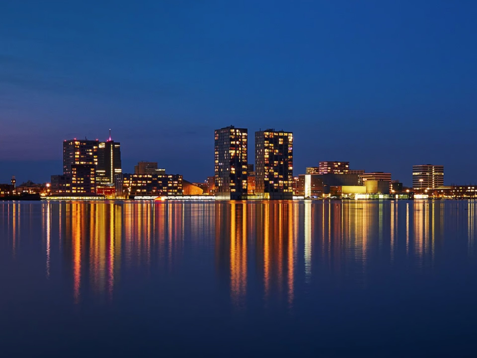 Skyline view of Amersfoort showcasing modern architecture against a vibrant sunset. Skyline view of Amersfoort showcasing modern architecture against a vibrant sunset.