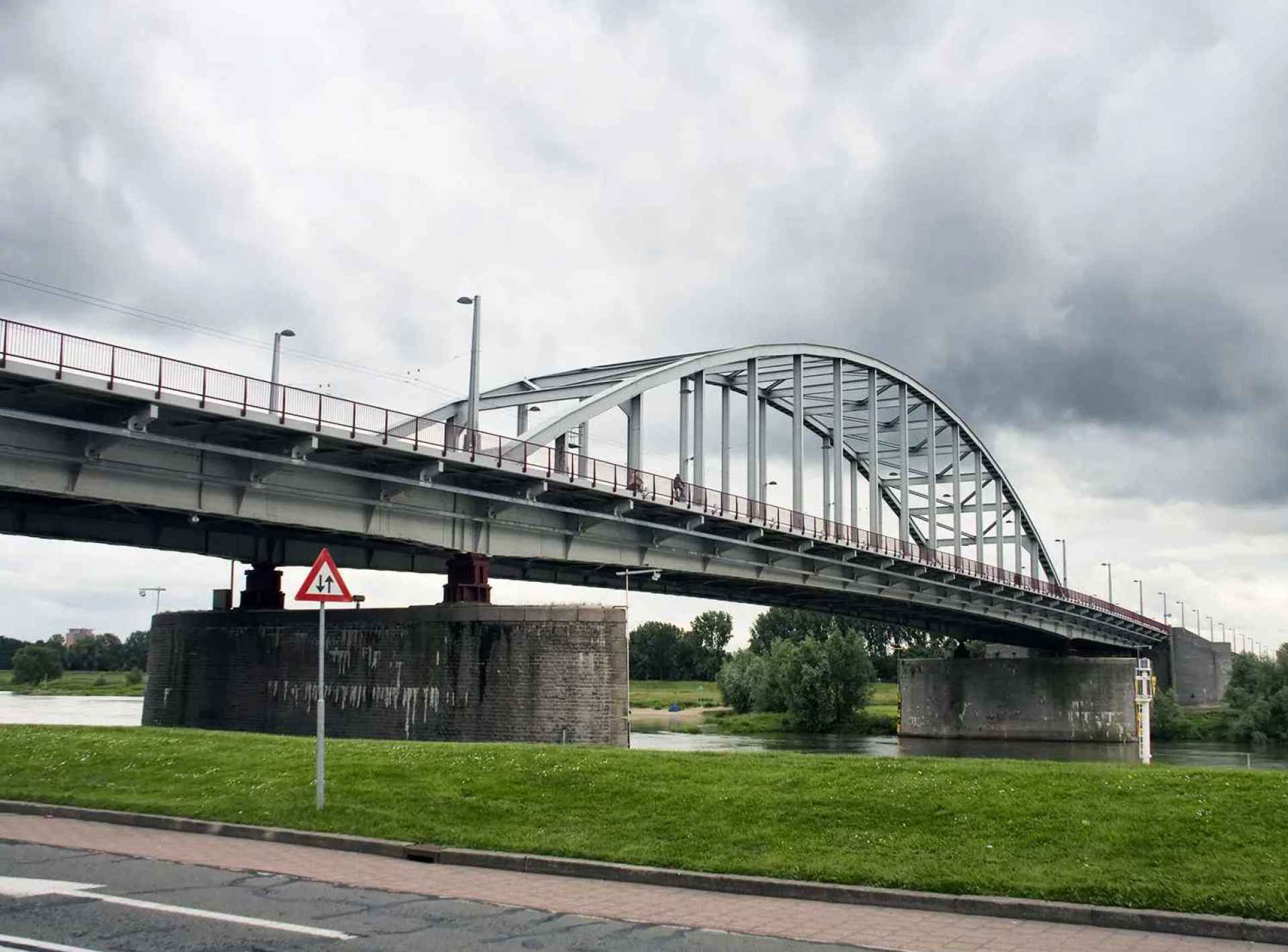 Image of the John Frost Bridge in Arnhem, showcasing its unique architecture against a clear blue sky. Image of the John Frost Bridge in Arnhem, showcasing its unique architecture against a clear blue sky.