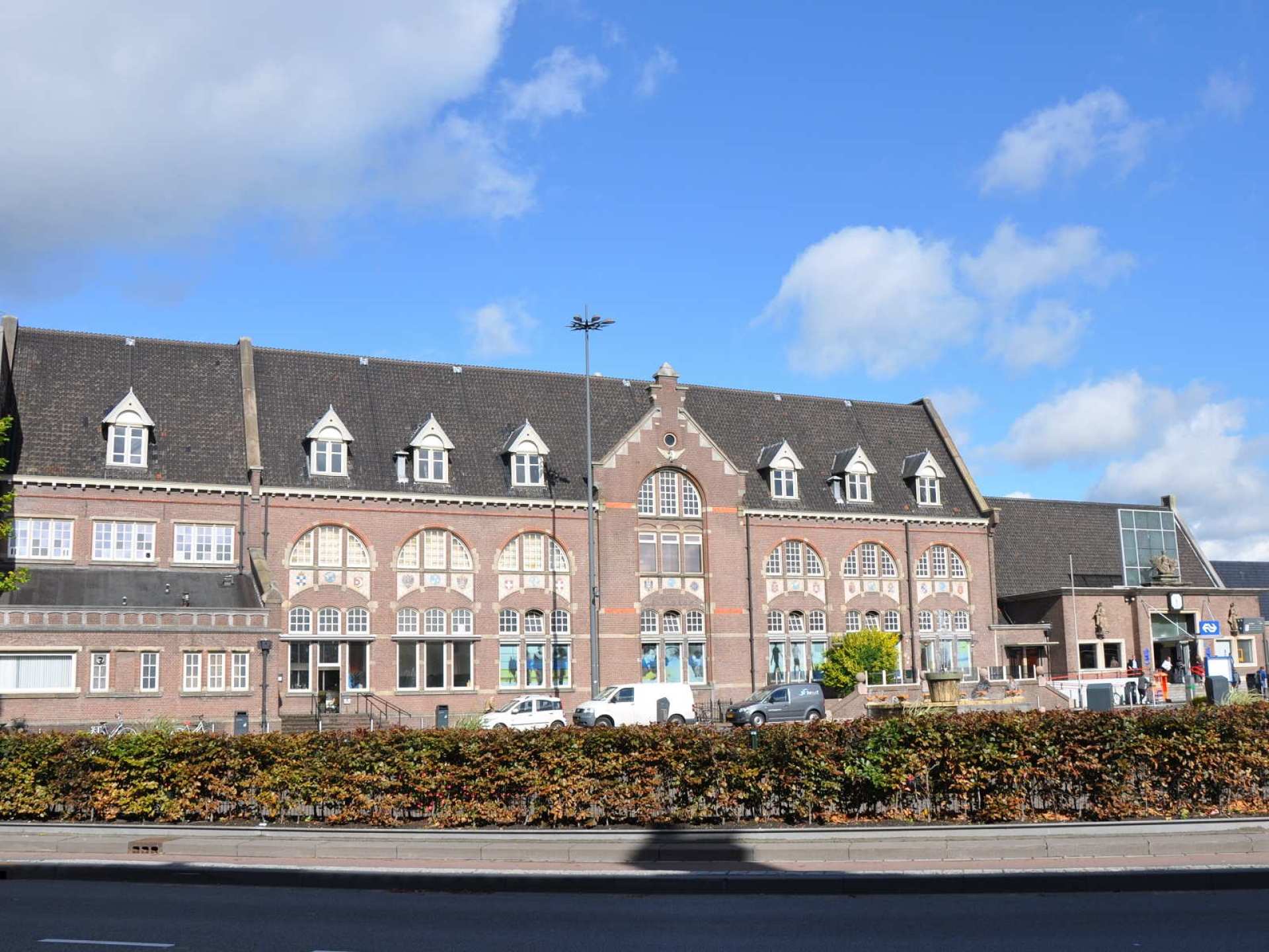 Train station in Roosendaal, Netherlands, featuring modern architecture and commuters navigating the platforms. Train station in Roosendaal, Netherlands, featuring modern architecture and commuters navigating the platforms.