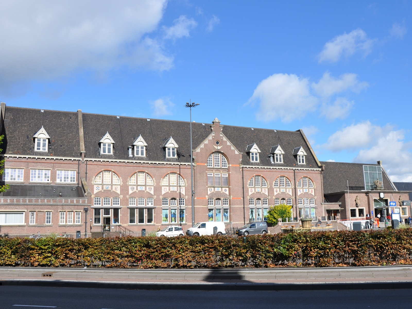 Train station in Roosendaal showcasing bustling activity and modern architecture, set against a clear blue sky. Train station in Roosendaal showcasing bustling activity and modern architecture, set against a clear blue sky.