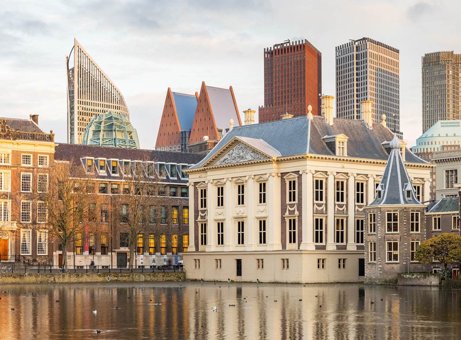 A stunning view of the Mauritshuis Museum in The Hague, showcasing its elegant architecture and beautiful surrounding landscape. A stunning view of the Mauritshuis Museum in The Hague, showcasing its elegant architecture and beautiful surrounding landscape.