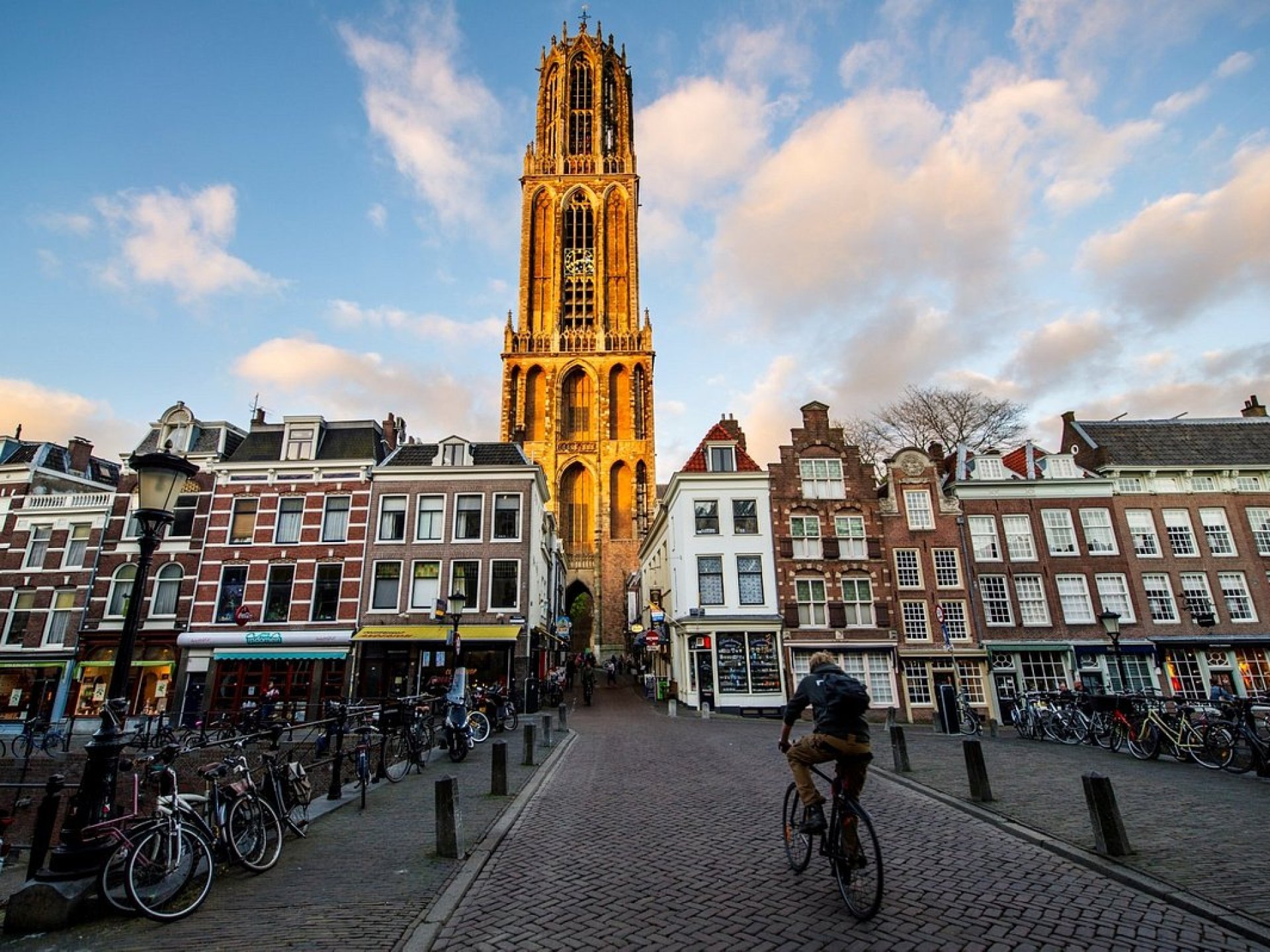 The iconic Dom Tower rising above the city skyline of Utrecht, showcasing its stunning Gothic architecture against a clear blue sky. The iconic Dom Tower rising above the city skyline of Utrecht, showcasing its stunning Gothic architecture against a clear blue sky.