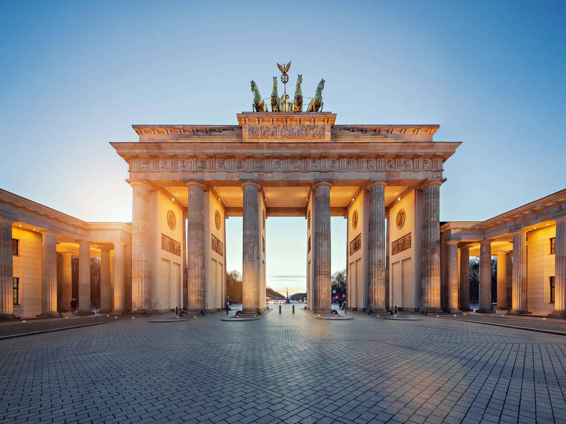 A view of the iconic Brandenburg Gate in Berlin, showcasing its historic architecture against a clear blue sky. A view of the iconic Brandenburg Gate in Berlin, showcasing its historic architecture against a clear blue sky.