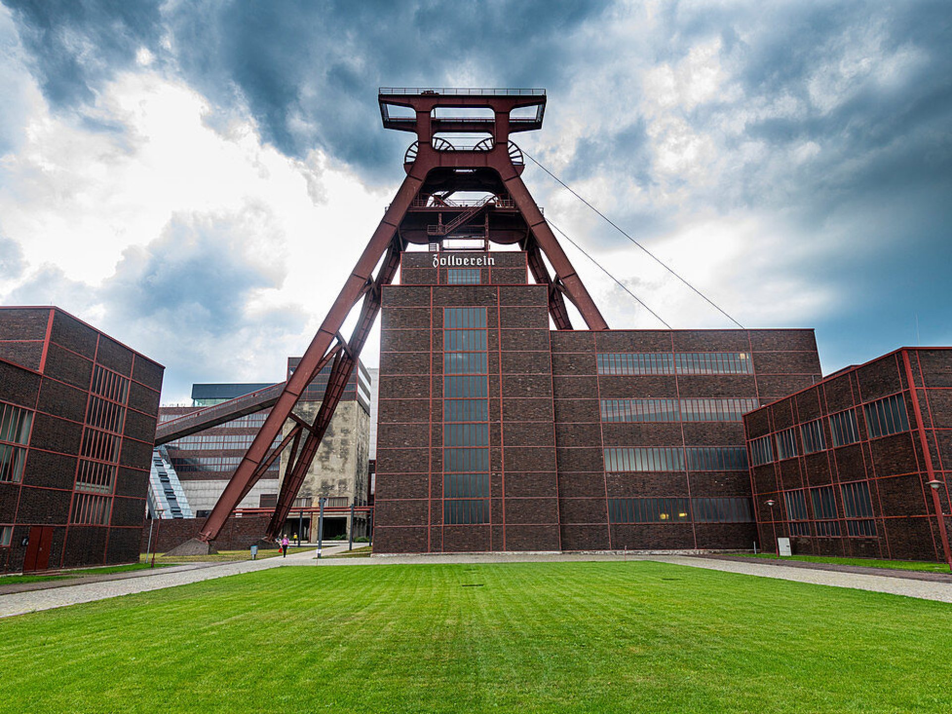 Aerial view of the historic Zollverein Coal Mine in Essen, showcasing its impressive industrial architecture and surrounding greenery. Aerial view of the historic Zollverein Coal Mine in Essen, showcasing its impressive industrial architecture and surrounding greenery.
