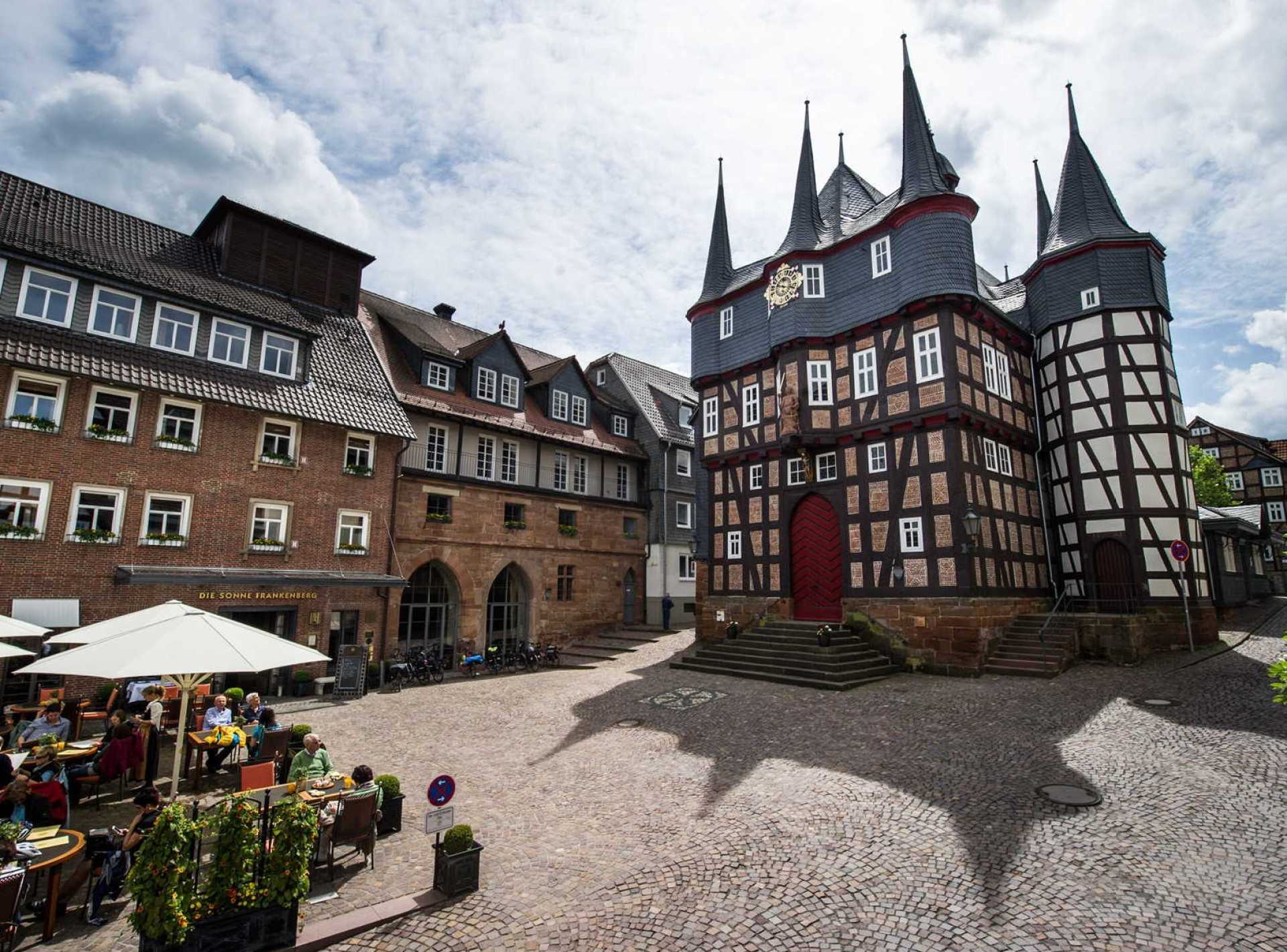 Alt text: Beautiful view of Herzhausen Castle in Kassel, Germany, surrounded by lush greenery and a clear blue sky. Alt text: Beautiful view of Herzhausen Castle in Kassel, Germany, surrounded by lush greenery and a clear blue sky.