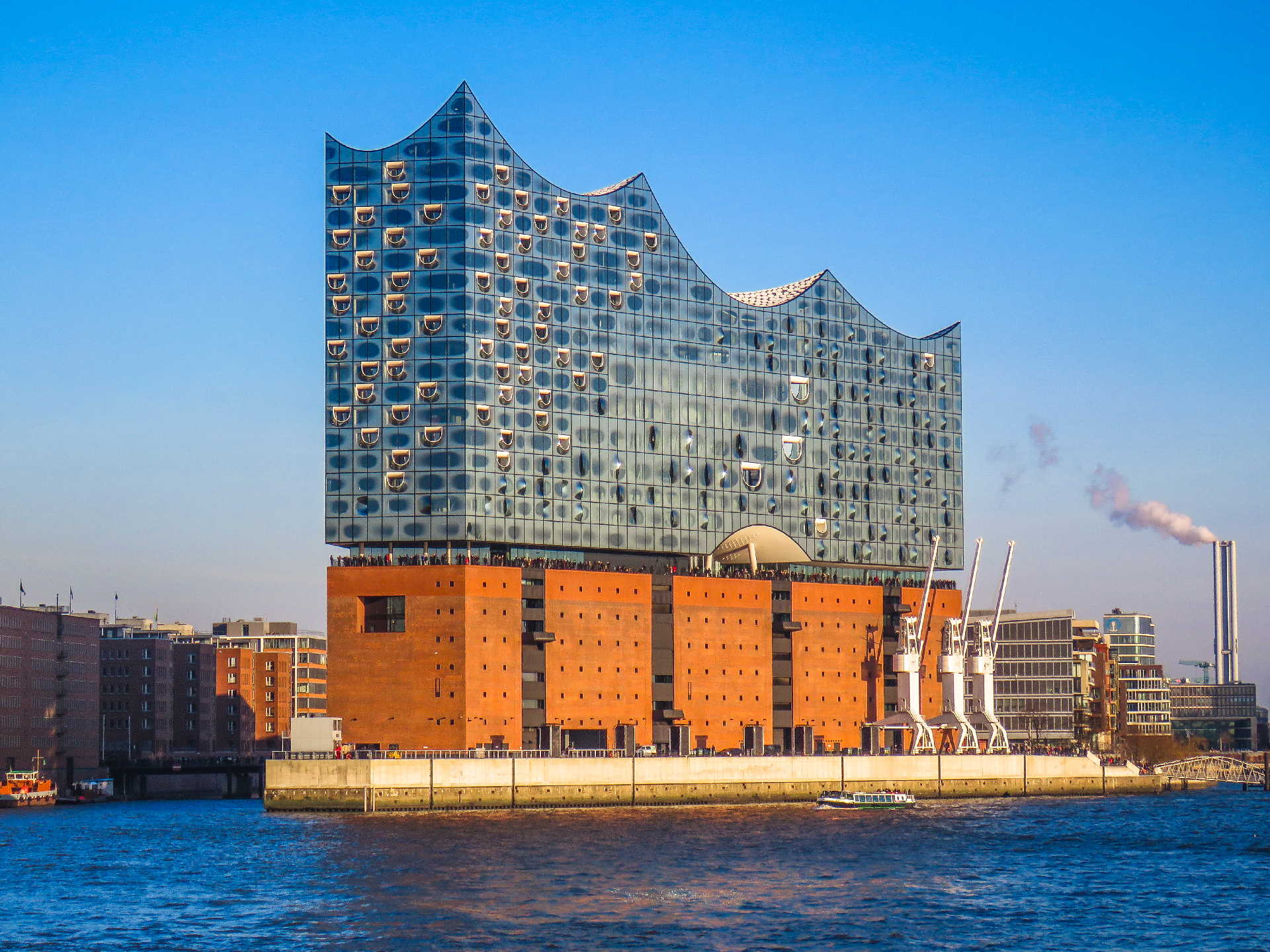 A stunning view of the Elbphilharmonie concert hall in Hamburg, showcasing its unique architecture and vibrant waterfront setting. A stunning view of the Elbphilharmonie concert hall in Hamburg, showcasing its unique architecture and vibrant waterfront setting.