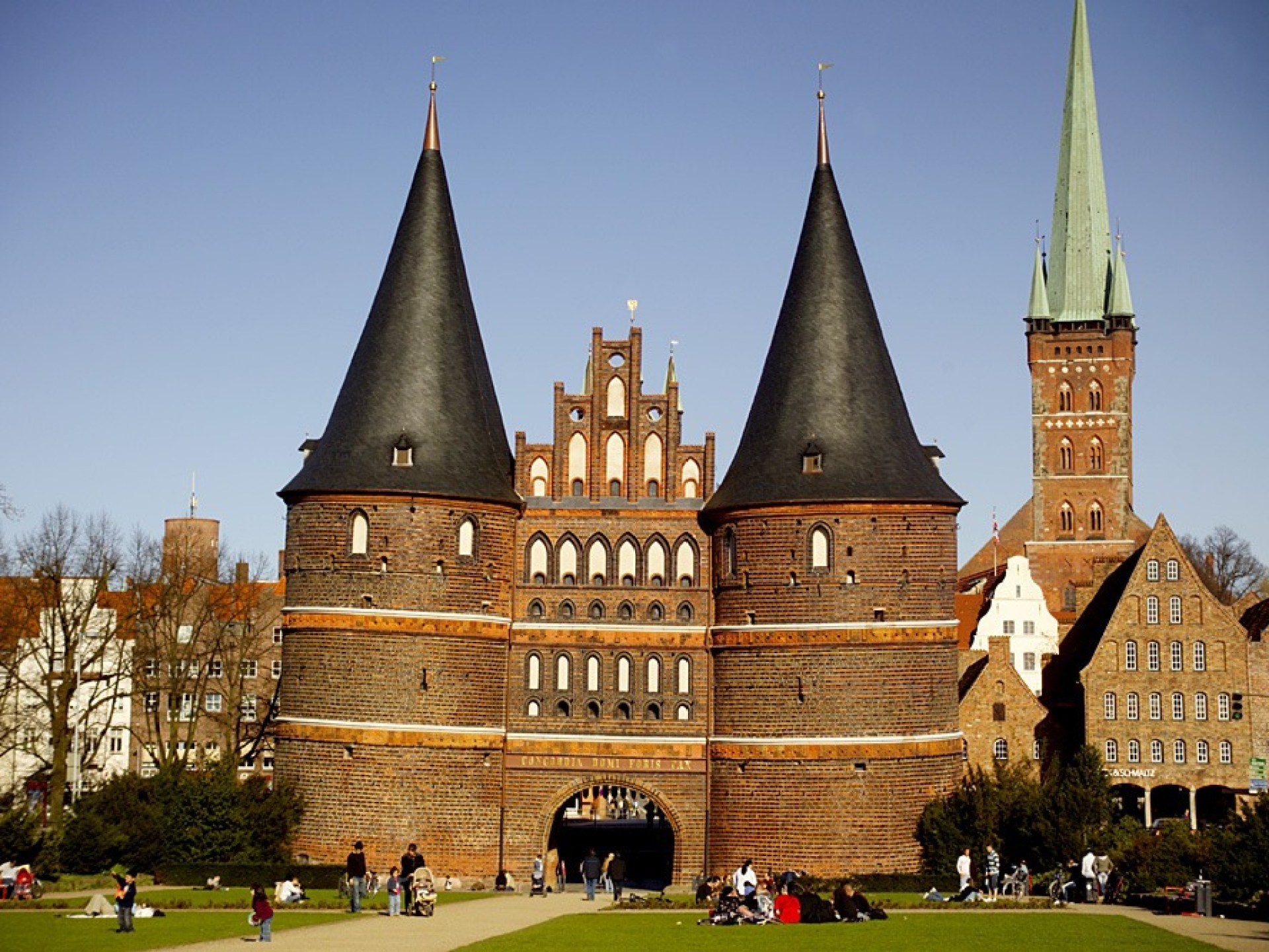 View of the iconic Holstentor Gate in Lubeck, Germany, showcasing its historic architecture and surrounding scenery. View of the iconic Holstentor Gate in Lubeck, Germany, showcasing its historic architecture and surrounding scenery.