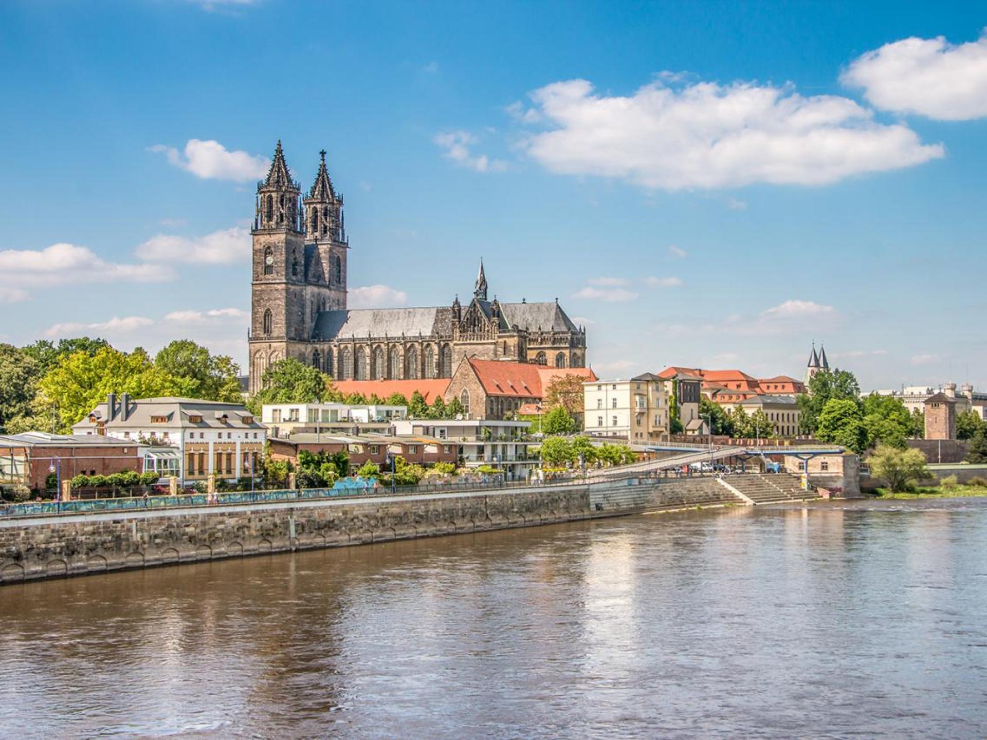 A stunning view of Magdeburg Cathedral showcasing its impressive architecture against a clear blue sky. A stunning view of Magdeburg Cathedral showcasing its impressive architecture against a clear blue sky.