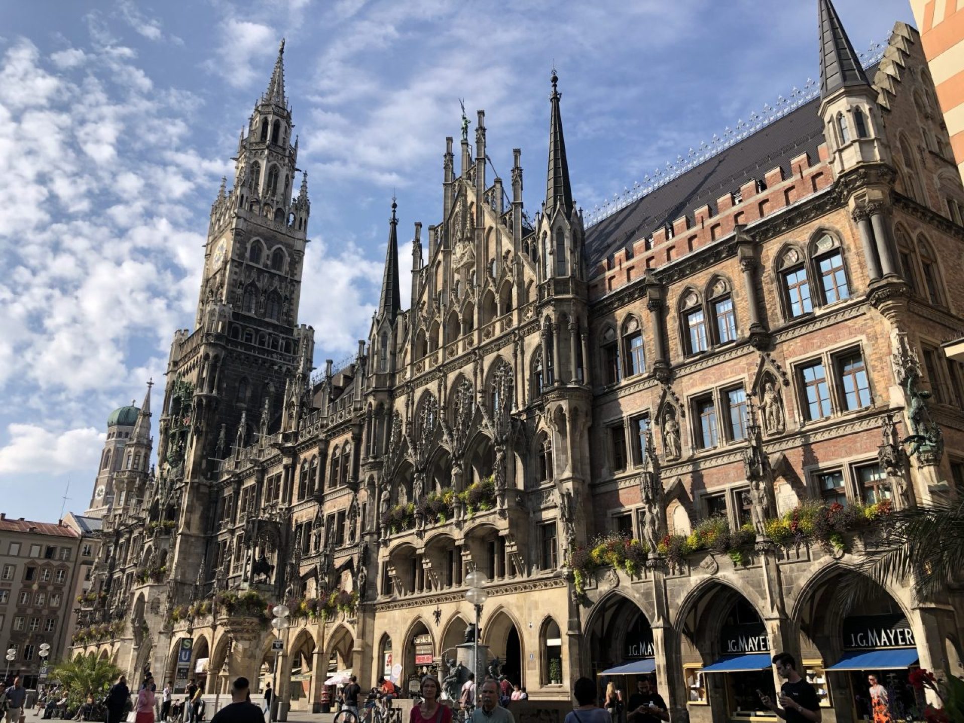 A view of Munich's Marienplatz featuring the iconic Glockenspiel, showcasing a vibrant city square filled with visitors. A view of Munich's Marienplatz featuring the iconic Glockenspiel, showcasing a vibrant city square filled with visitors.