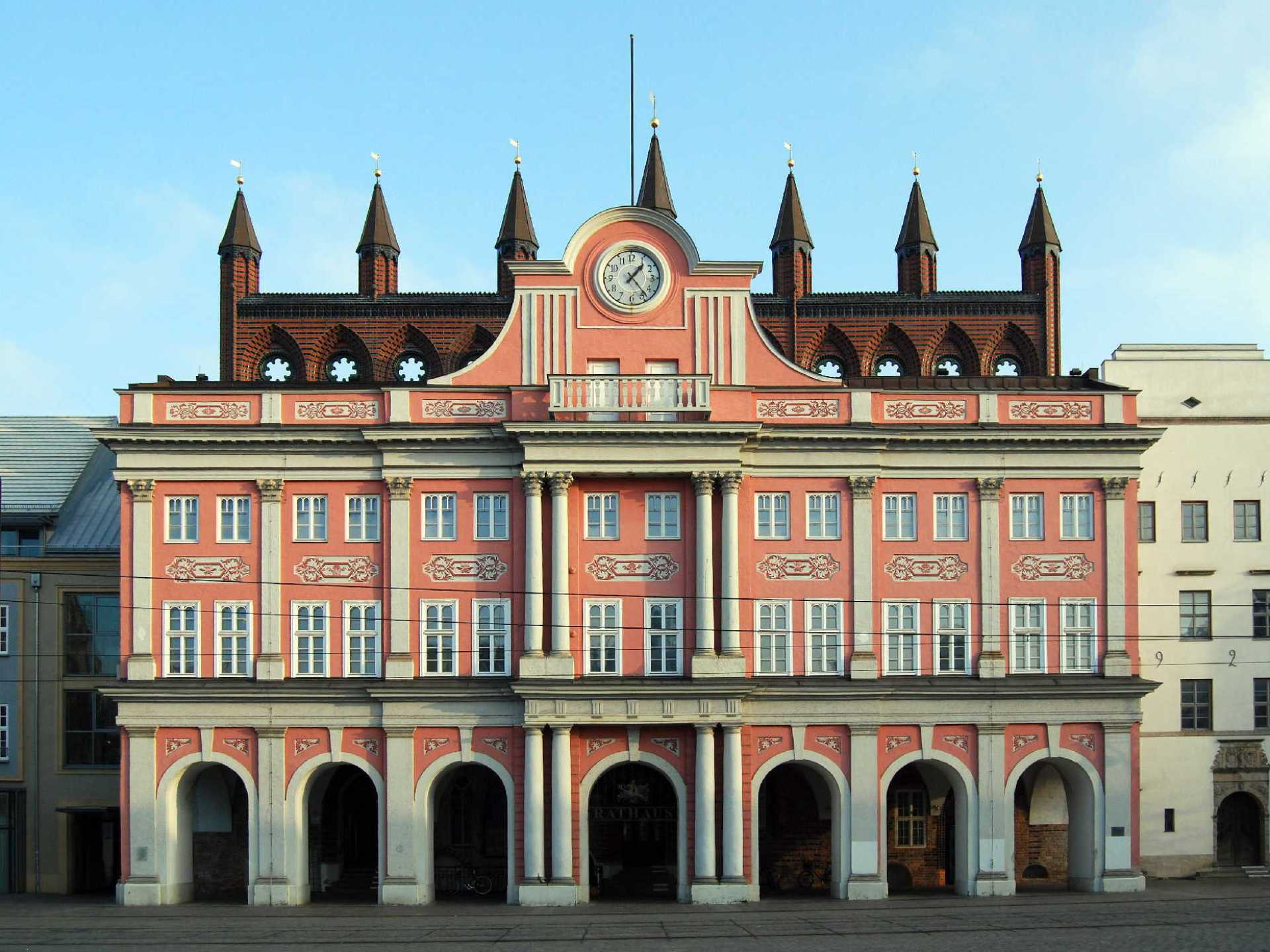 Historic city hall in Rostock showcasing stunning architecture and vibrant atmosphere on a sunny day. Historic city hall in Rostock showcasing stunning architecture and vibrant atmosphere on a sunny day.
