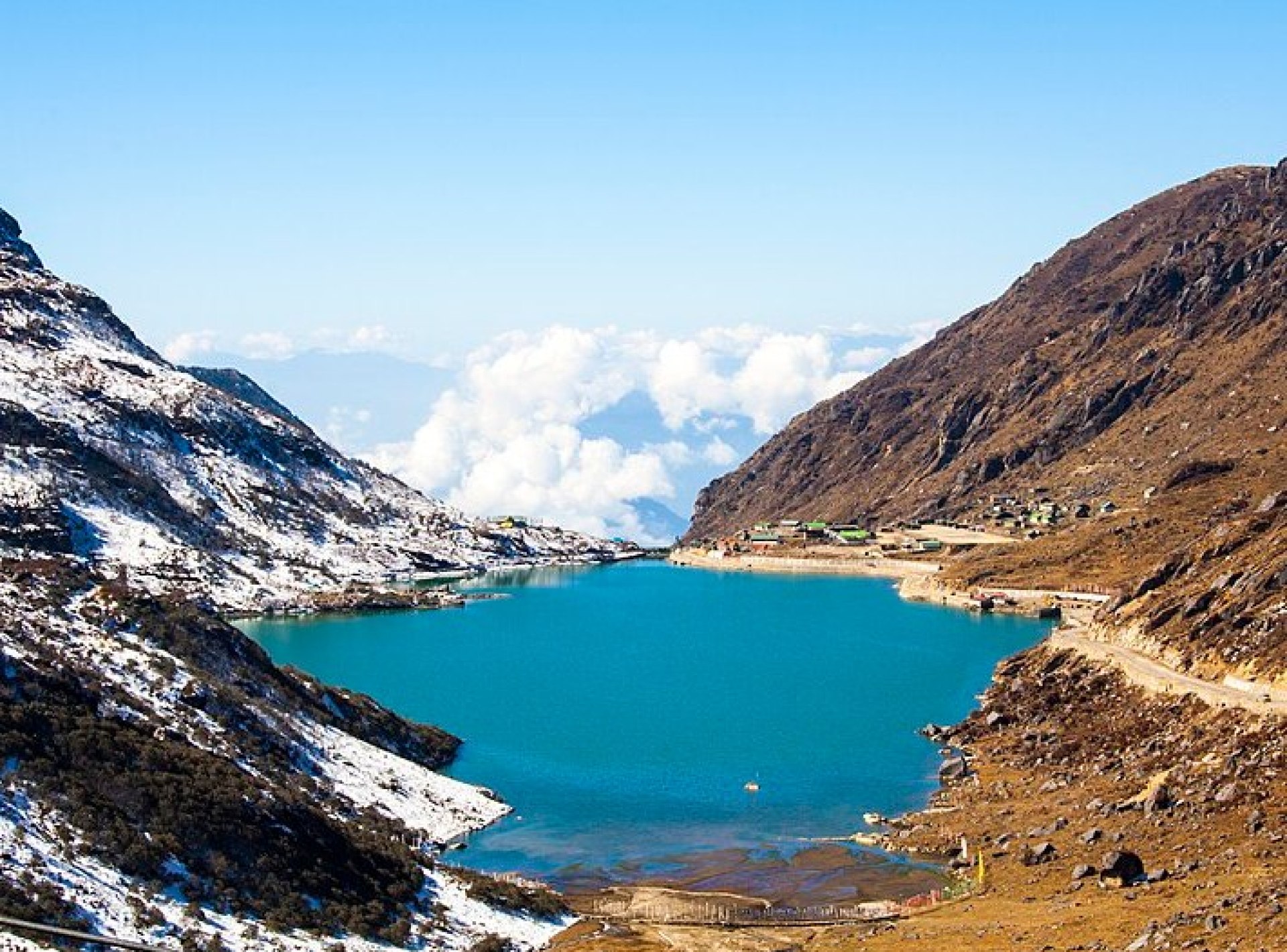 Scenic view of Changu Lake surrounded by mountains in Gangtok, showcasing the natural beauty of this captivating location. Scenic view of Changu Lake surrounded by mountains in Gangtok, showcasing the natural beauty of this captivating location.