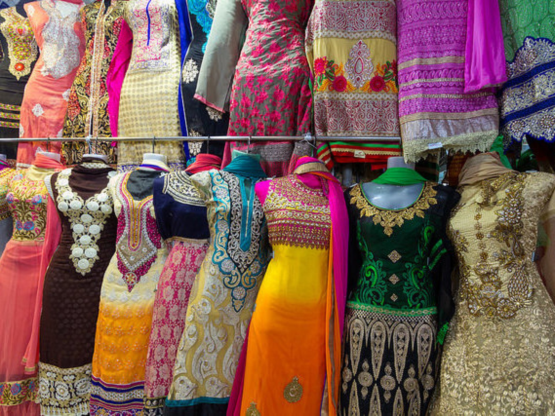 A vibrant textile shop showcasing colorful fabrics and traditional garments in Surat, India, bustling with customers. A vibrant textile shop showcasing colorful fabrics and traditional garments in Surat, India, bustling with customers.
