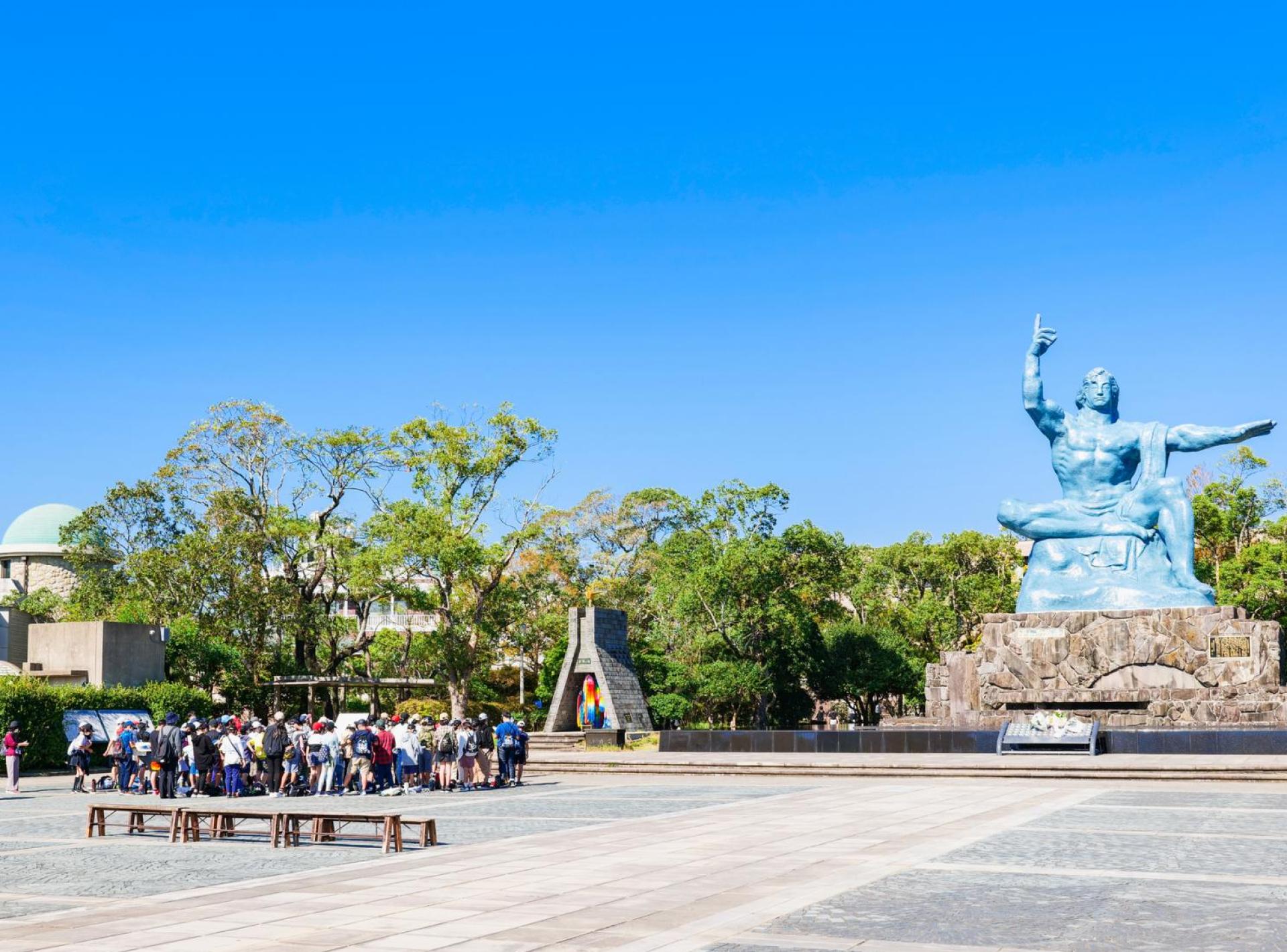 A serene view of Nagasaki Peace Park, featuring lush greenery and a tranquil atmosphere, symbolizing hope and remembrance. A serene view of Nagasaki Peace Park, featuring lush greenery and a tranquil atmosphere, symbolizing hope and remembrance.