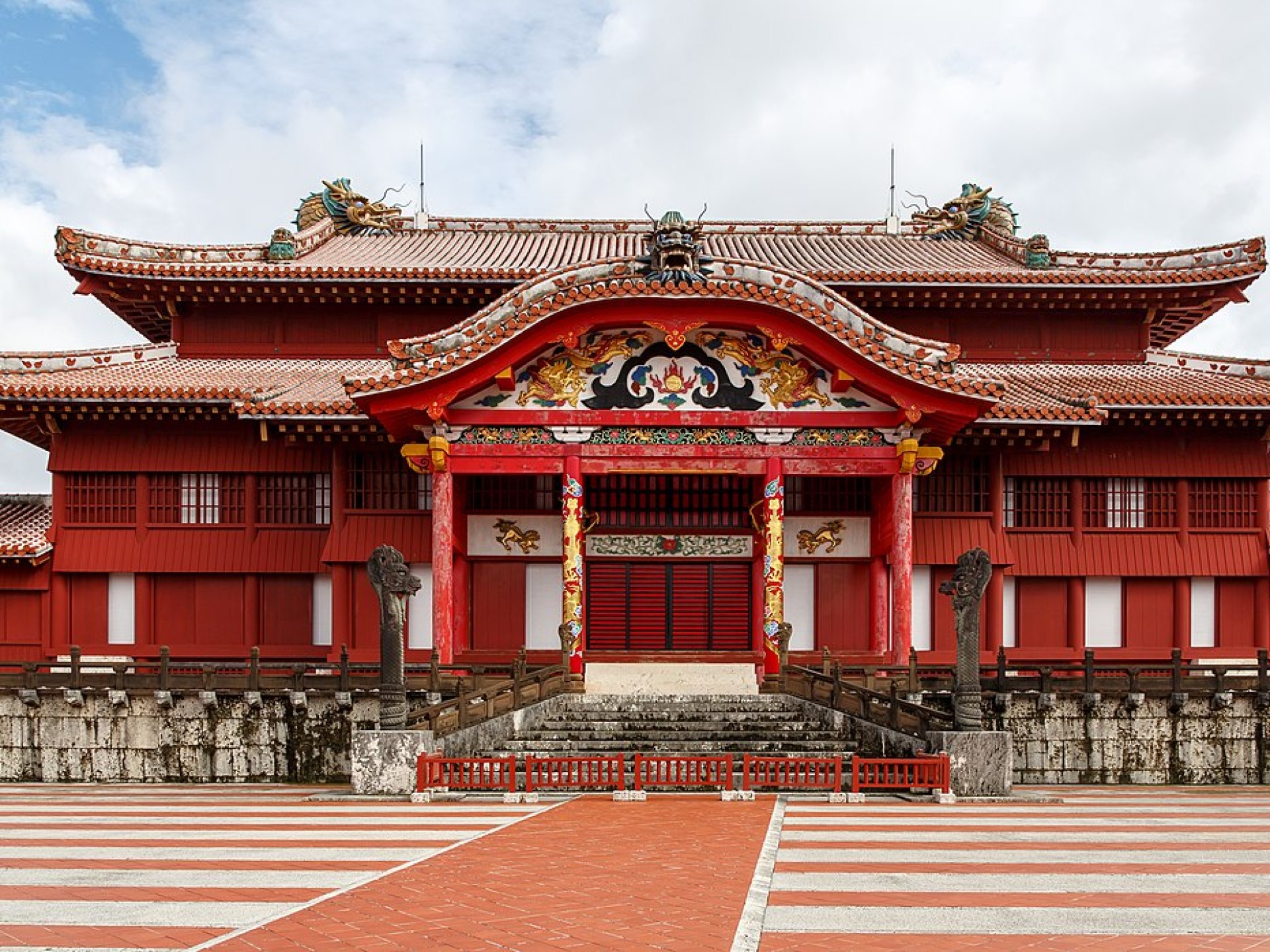 Scenic view of Shuri Castle in Naha, Japan, showcasing its impressive architecture and lush surroundings. Scenic view of Shuri Castle in Naha, Japan, showcasing its impressive architecture and lush surroundings.