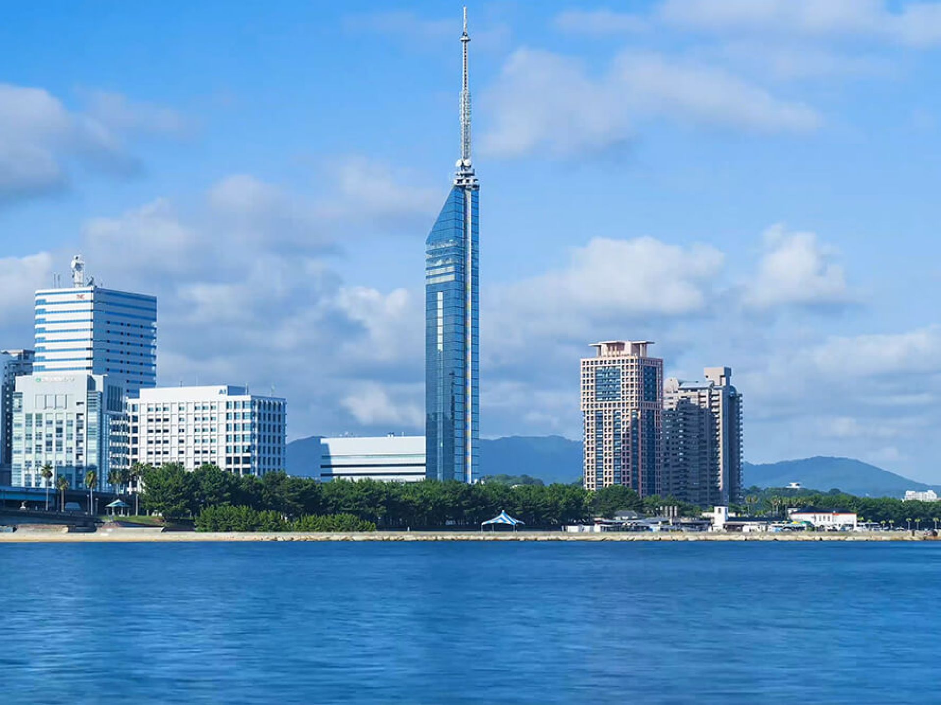 Fukuoka Tower towering over the beautiful skyline with a clear blue sky in Fukuoka, Japan. Fukuoka Tower towering over the beautiful skyline with a clear blue sky in Fukuoka, Japan.