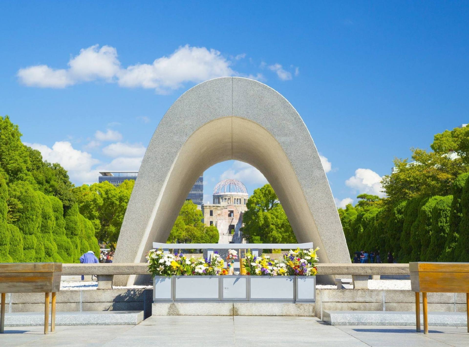 A serene view of Hiroshima Peace Memorial Park showcasing its lush greenery and historic monuments dedicated to peace. A serene view of Hiroshima Peace Memorial Park showcasing its lush greenery and historic monuments dedicated to peace.