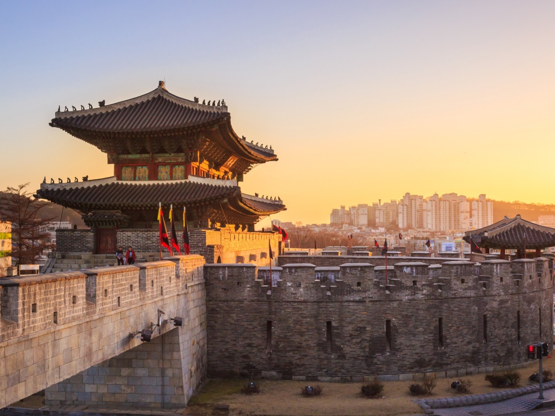 A panoramic view of Suwon's Hwaseong Fortress showcasing its historic architecture and beautiful landscape. A panoramic view of Suwon's Hwaseong Fortress showcasing its historic architecture and beautiful landscape.