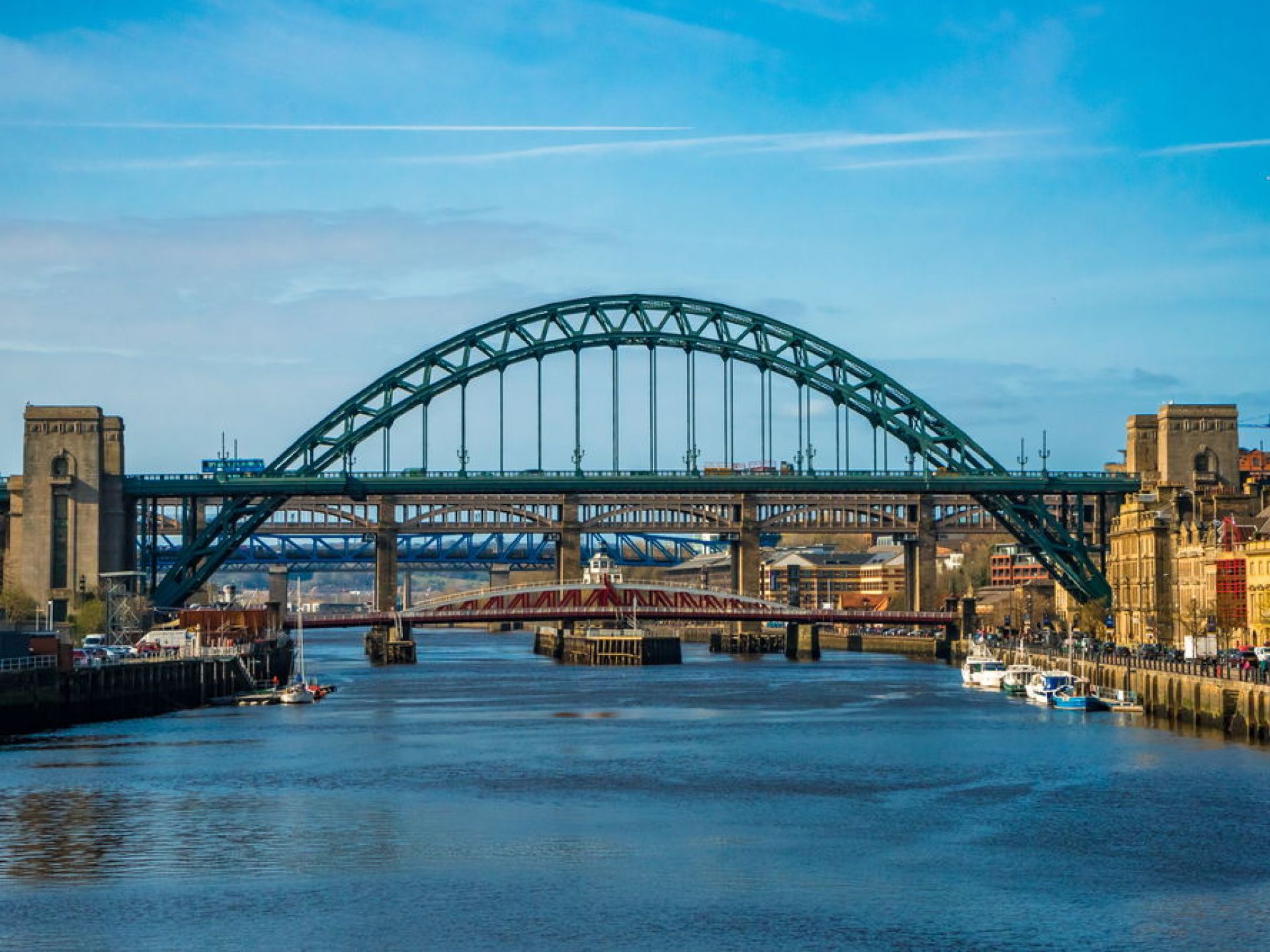 The Tyne Bridge spanning the River Tyne in Newcastle, UK, showcasing iconic architecture against a clear sky. The Tyne Bridge spanning the River Tyne in Newcastle, UK, showcasing iconic architecture against a clear sky.