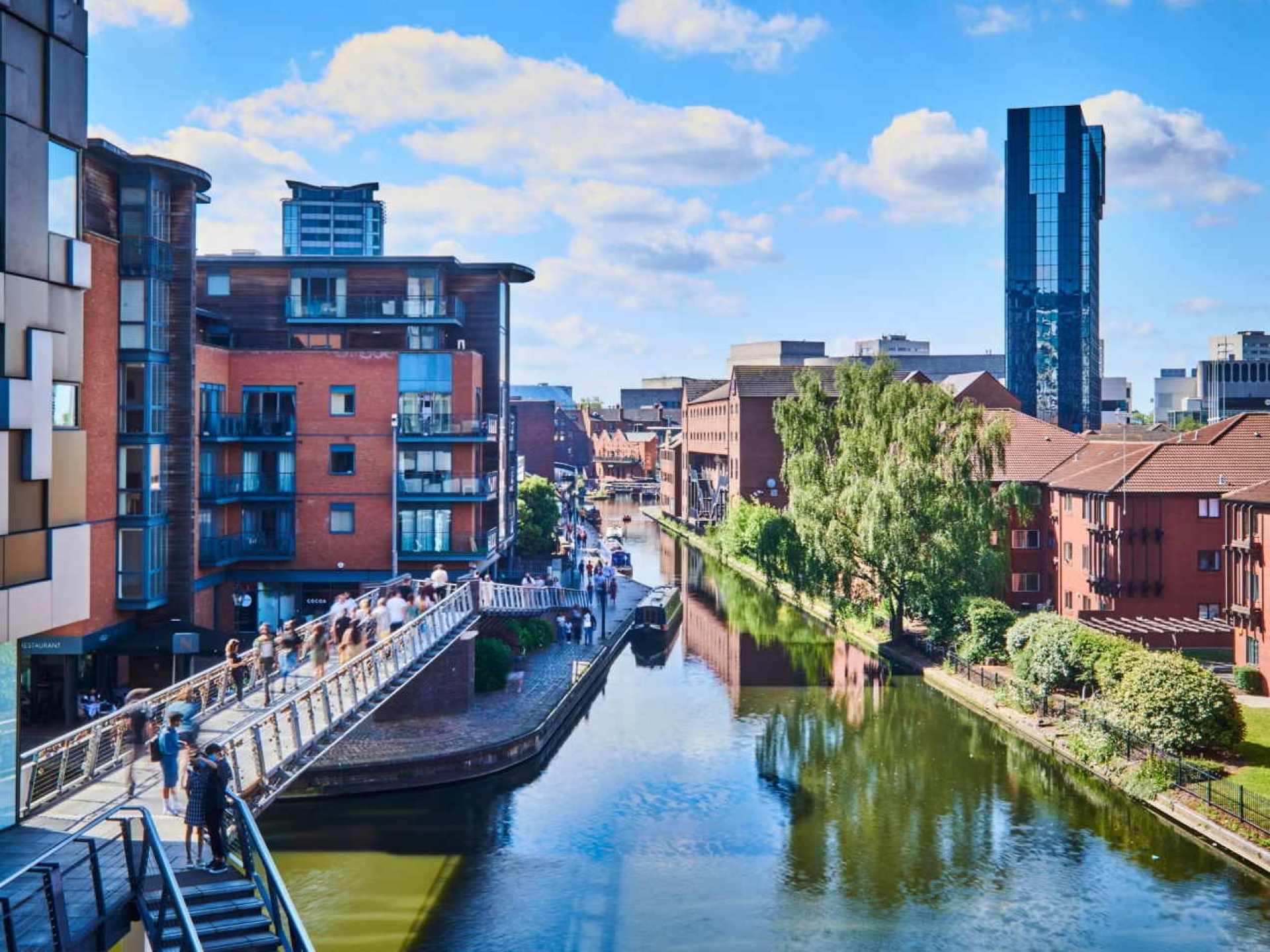 Vibrant view of Birmingham city showcasing its modern architecture and bustling urban atmosphere with greenery in the foreground. Vibrant view of Birmingham city showcasing its modern architecture and bustling urban atmosphere with greenery in the foreground.
