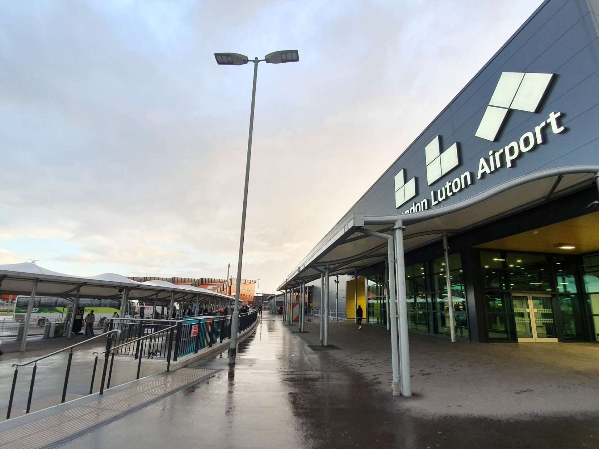 Luton Airport with a clear blue sky and runway, showcasing the busy travel hub in Luton, UK. Luton Airport with a clear blue sky and runway, showcasing the busy travel hub in Luton, UK.