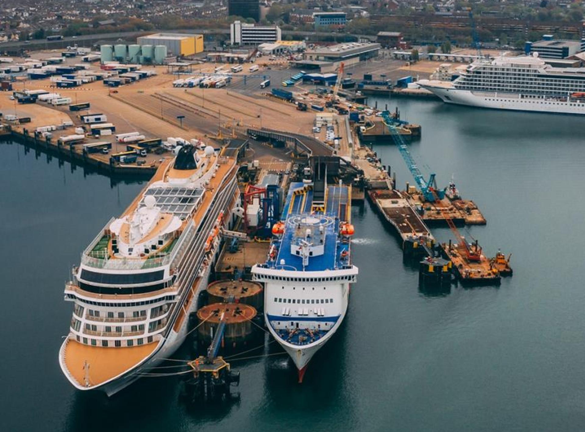 A scenic view of Portsmouth Harbour, showcasing boats and waterfront attractions in the lively coastal city of Portsmouth. A scenic view of Portsmouth Harbour, showcasing boats and waterfront attractions in the lively coastal city of Portsmouth.