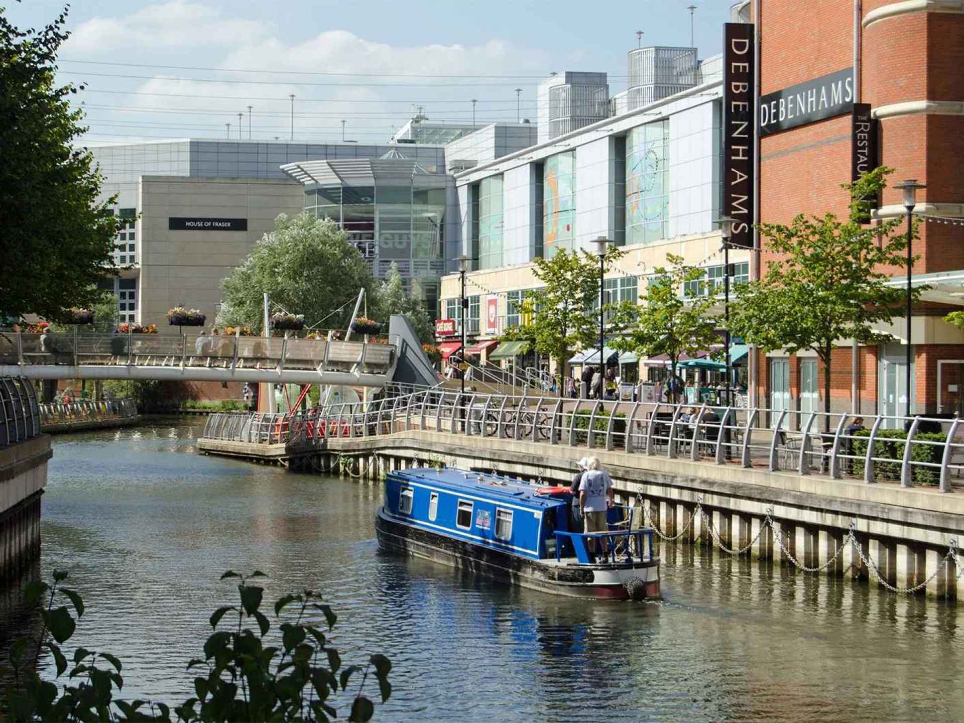 A scenic view of the River Kennet in Reading, showcasing lush greenery along the water's edge. A scenic view of the River Kennet in Reading, showcasing lush greenery along the water's edge.