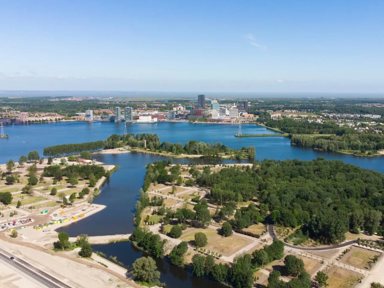 A scenic view of Flevoland showcasing its beautiful landscapes and modern architecture under a clear blue sky. A scenic view of Flevoland showcasing its beautiful landscapes and modern architecture under a clear blue sky.