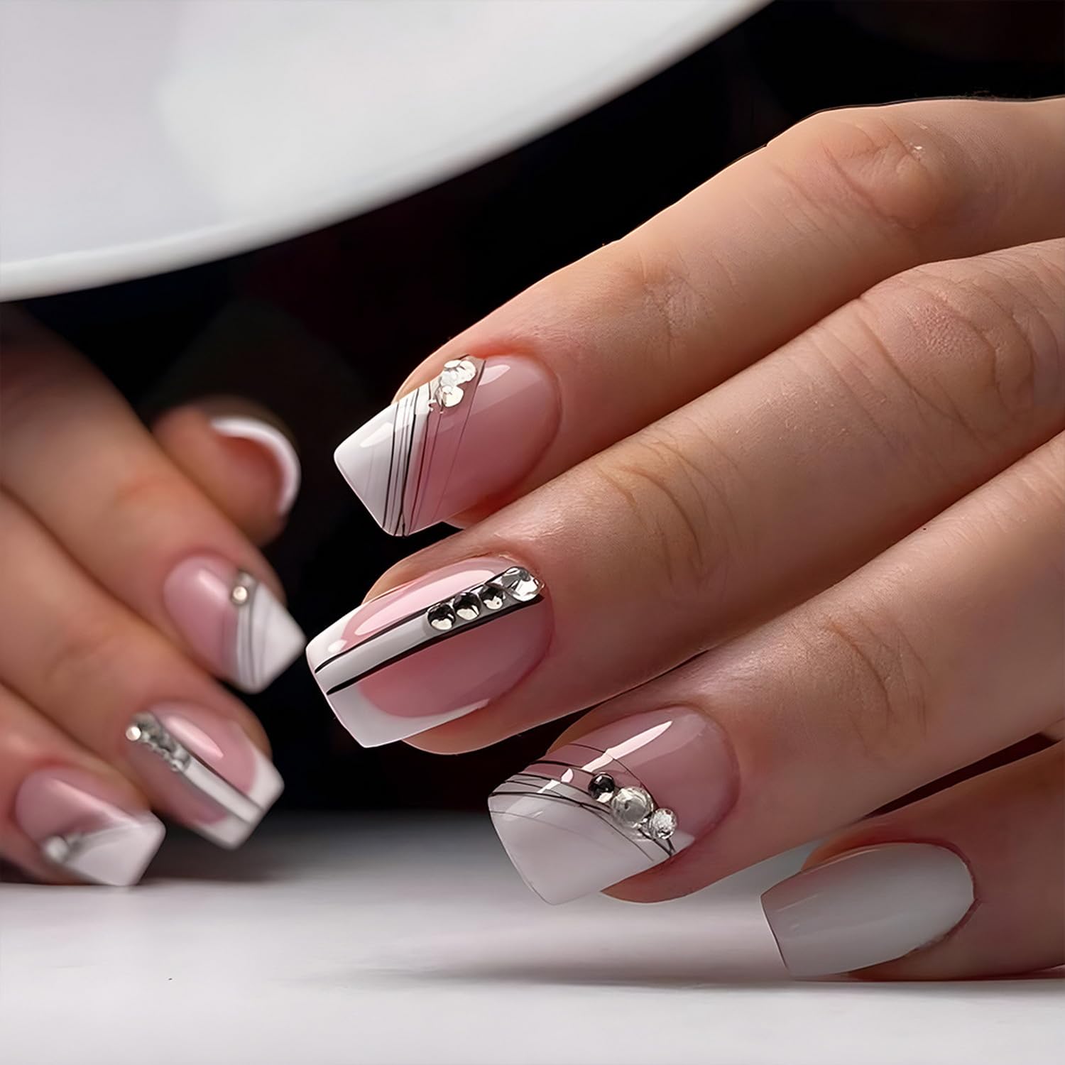 Uñas postizas a presión de punta francesa medianas con diseños de líneas negras, uñas adhesivas con diamantes de imitación blanco nude crema con