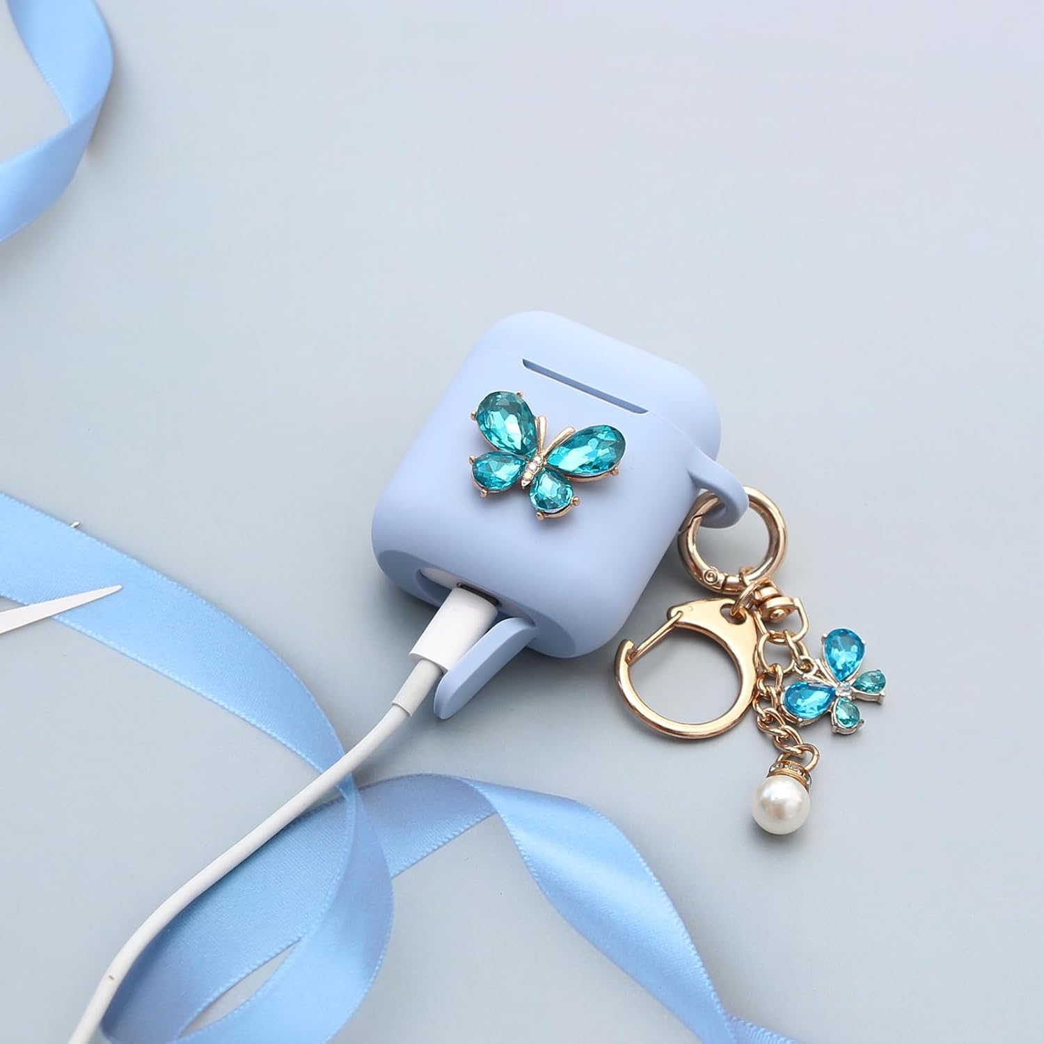 Wonhibo Funda de silicona para Airpod 1 y 2 de Apple, diseño de mariposas, color azul con llavero