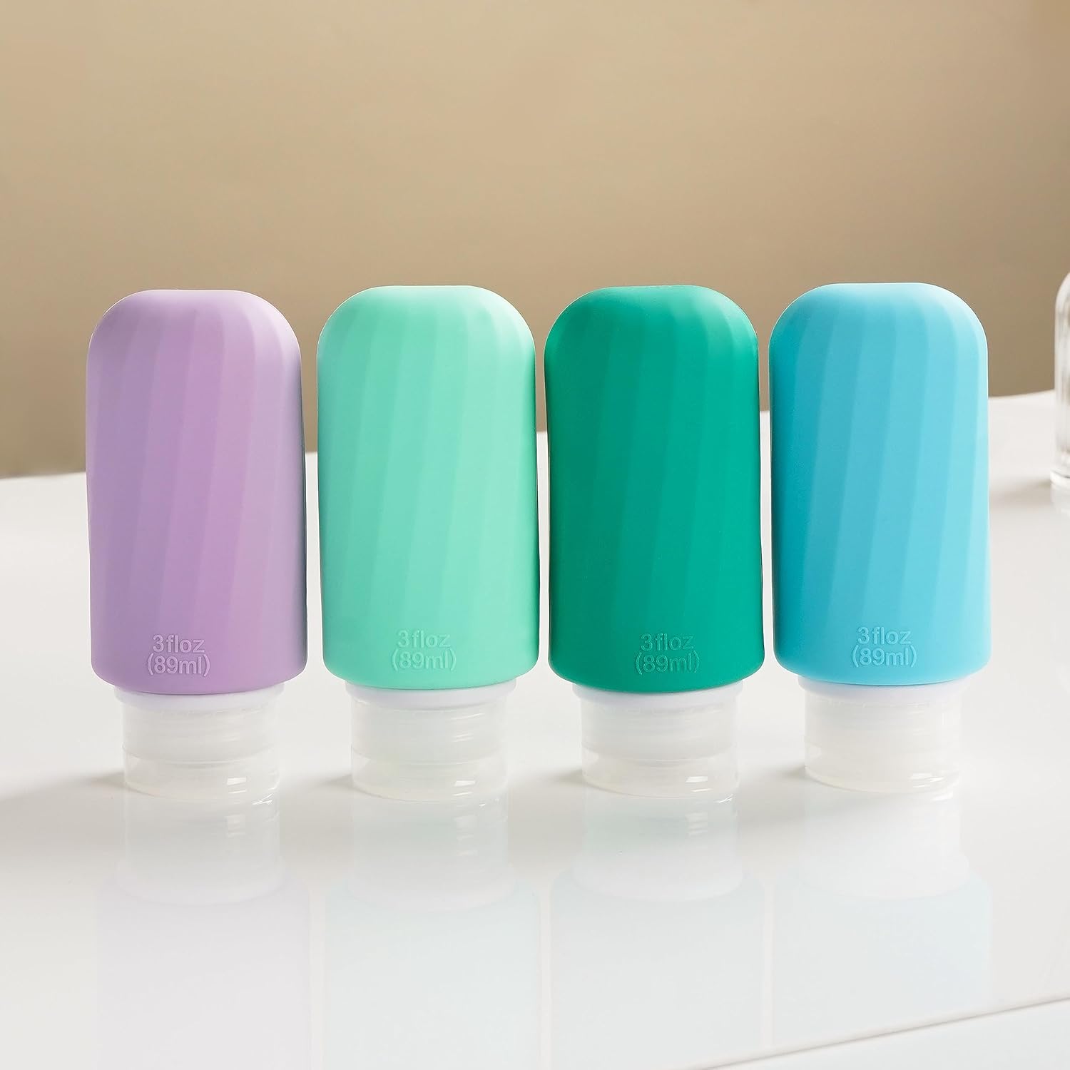 Juego de botellas de viaje de silicona portátiles para artículos de tocador, paquete de 4 recipientes de tamaño de viaje aprobados por la TSA con