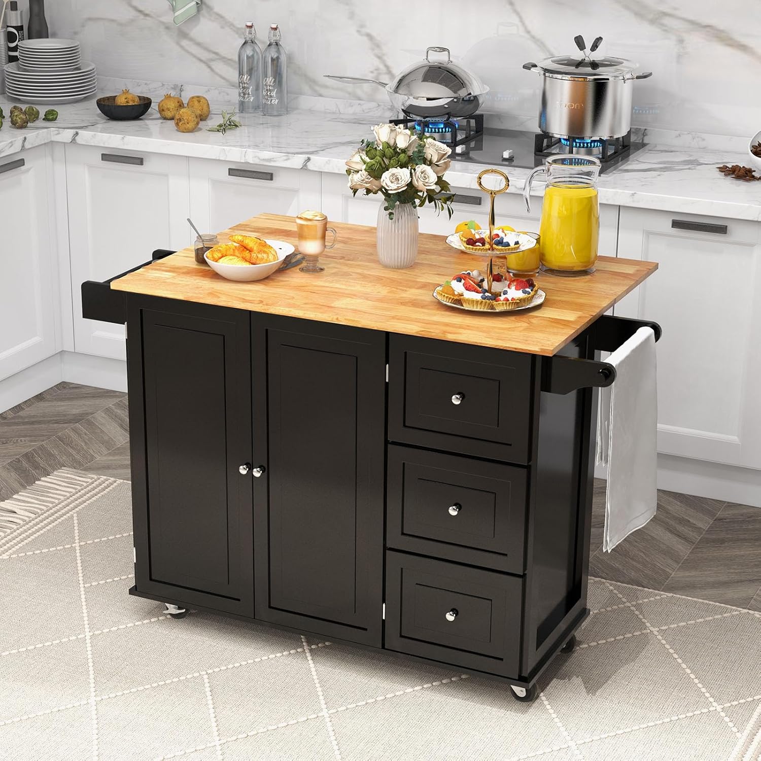 GOFLAME Carrito de isla de cocina con hoja caída, carrito de cocina con ruedas con parte superior de madera de goma, 3 cajones, toallero y estante
